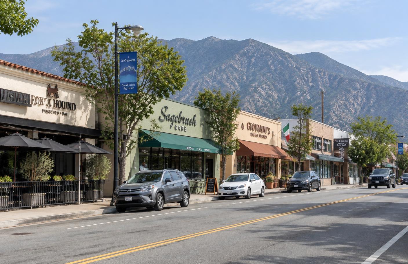 Storefronts and restaurants along Foothill Boulevard in La Crescenta with mountains behind